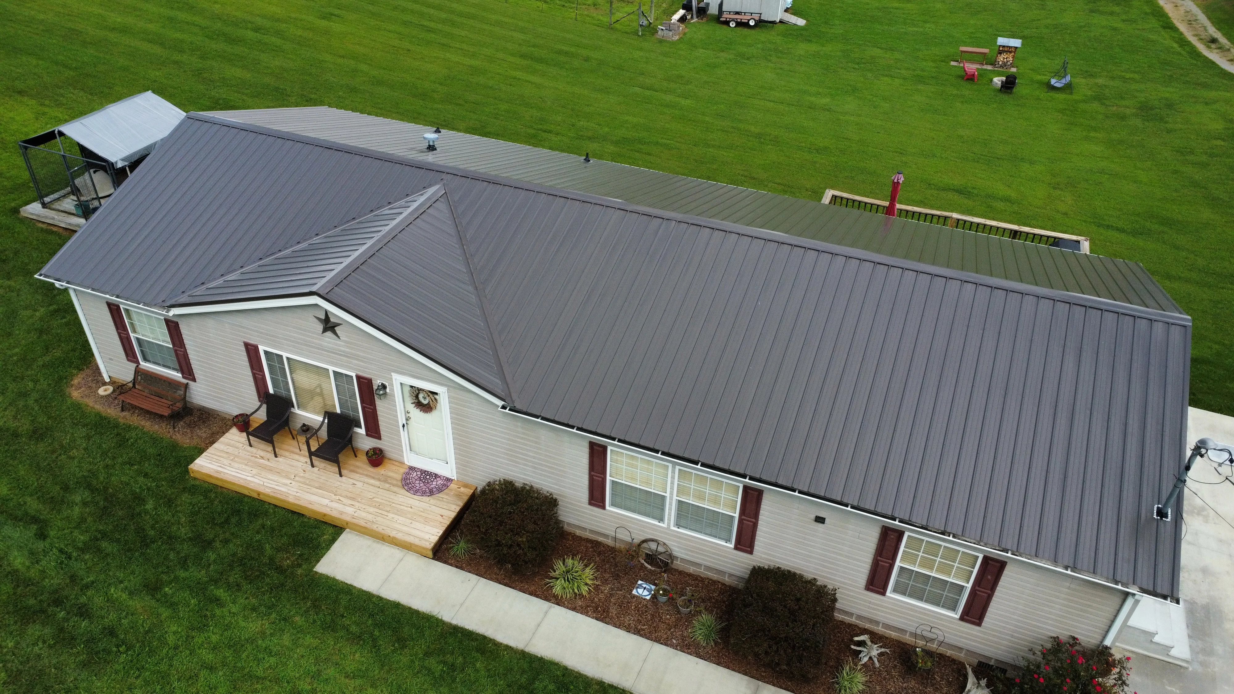 Home with a dark metal roof and deck - roofing in Bristol, TN