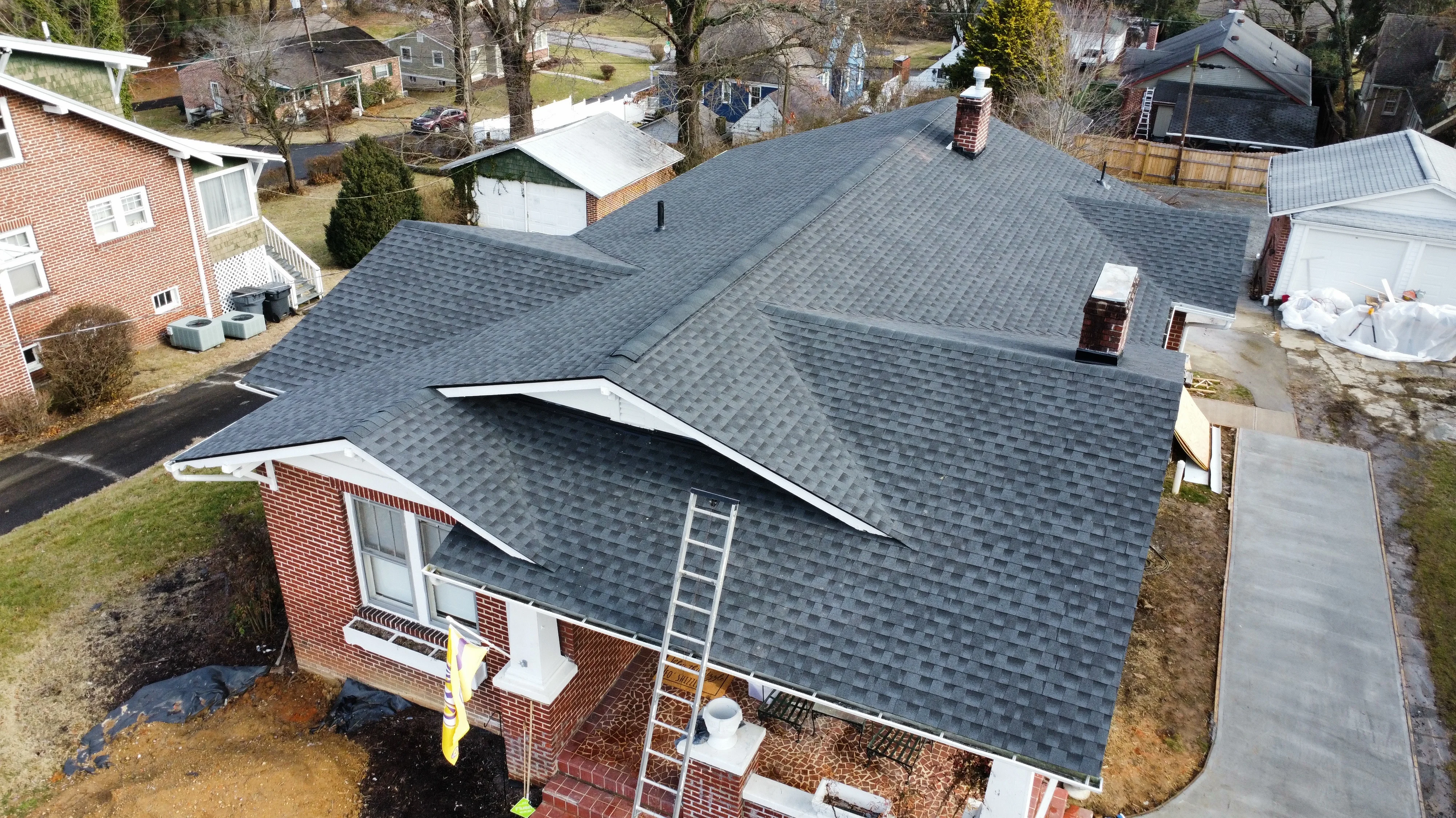 Brick home with a new grey shingle roof - roofing in Bristol, TN