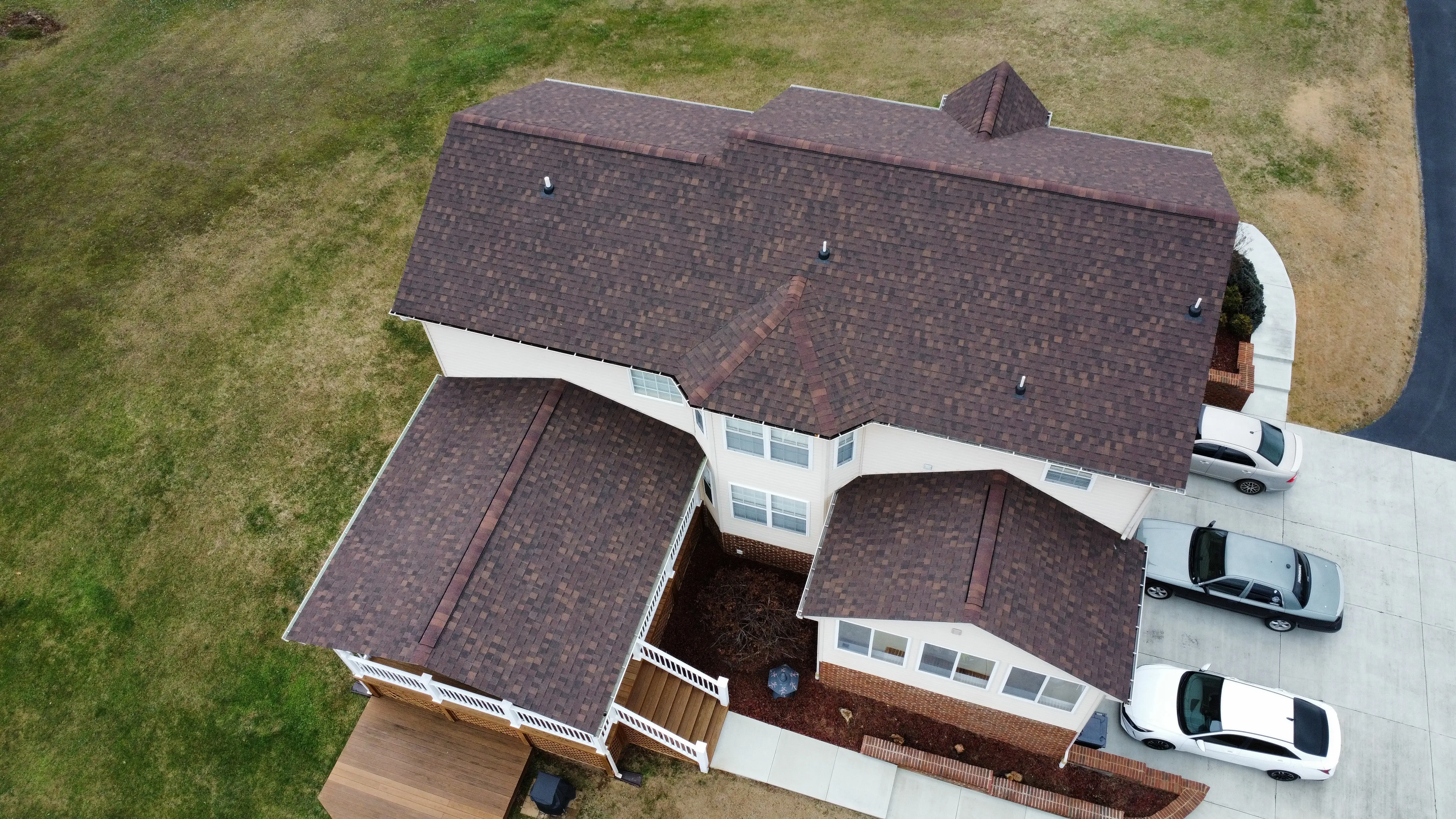 Large home with a finished shingle roof by White's Roofing Co